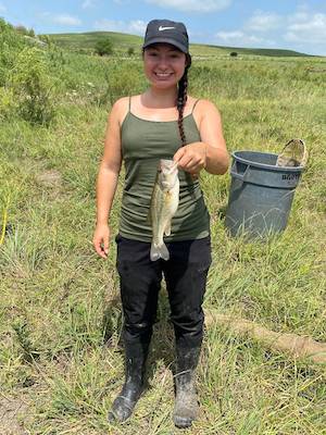 Photo of Krista Ward holding the 1,000th largemouth bass she sampled at Youngmeyer Ranch. 