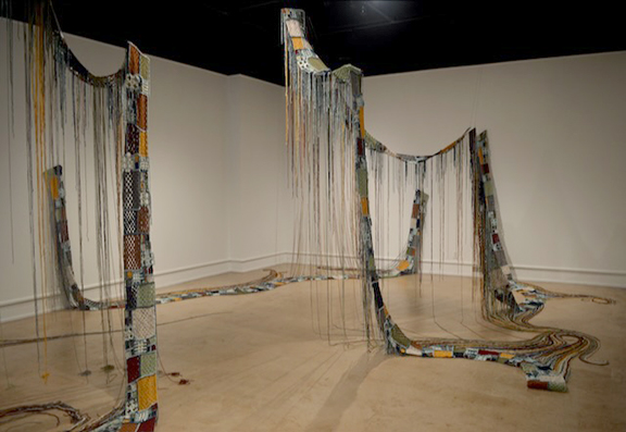 gallery image with hanging woven fabric