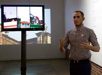 Nestor Sire discusses his work during an exhibition preview at WSU ShiftSpace