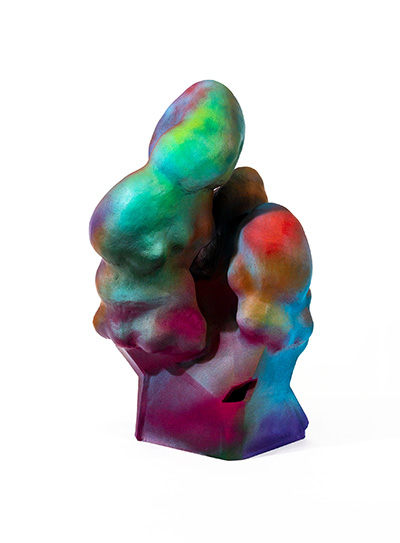 A brightly colored sculpture sits on a pillar