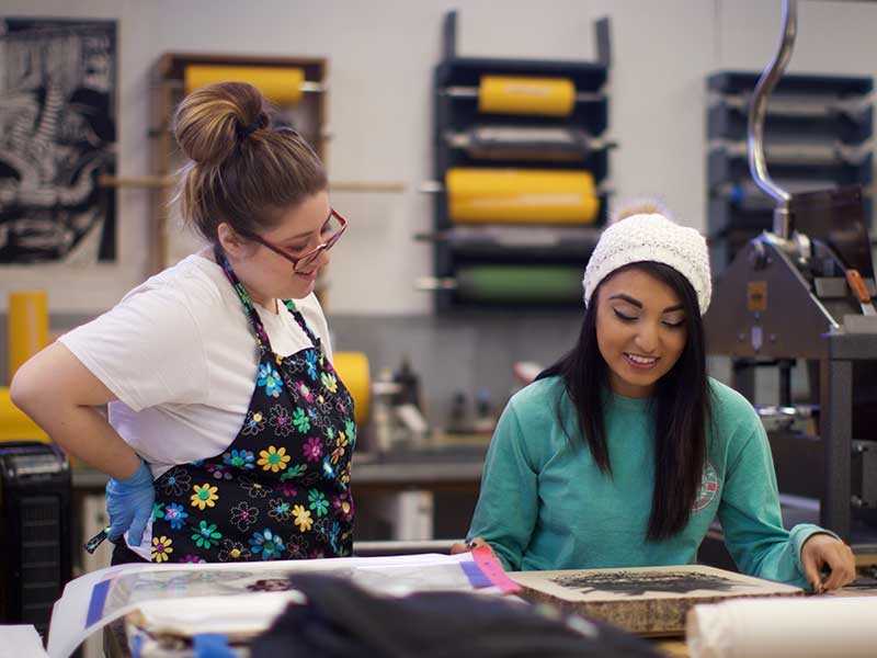 Two students in the printmaking studio