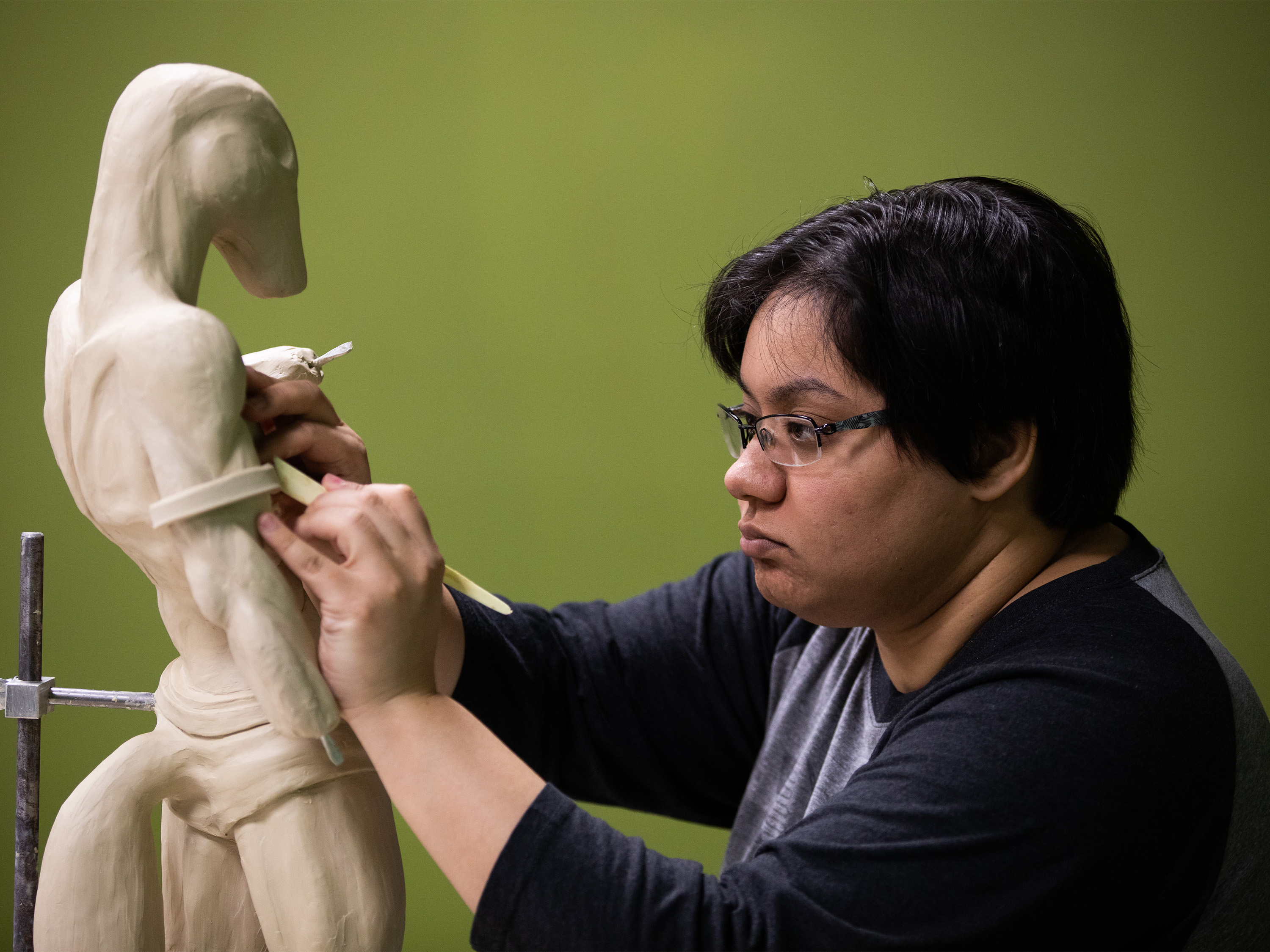 Student working on a clay sculpture.