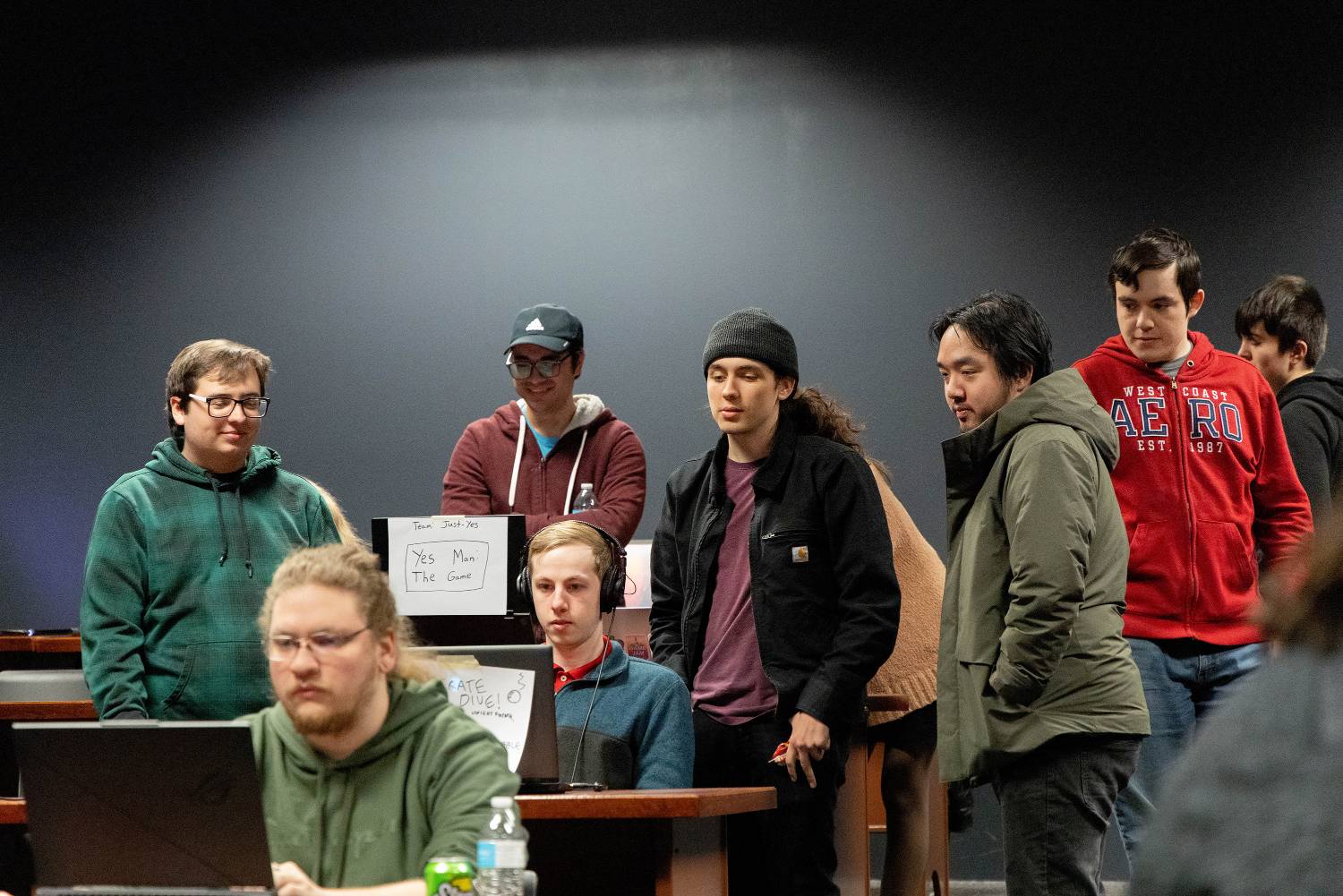 Students working on a laptop.