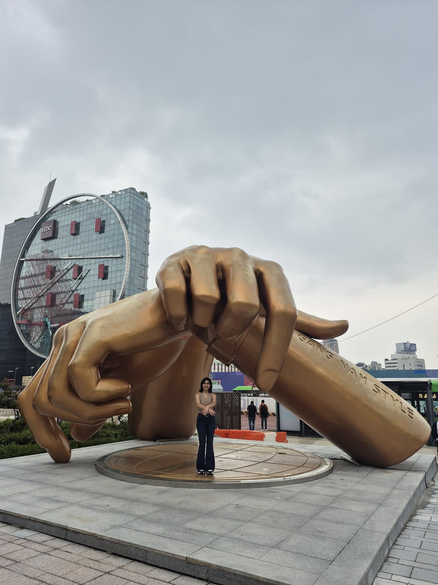 Yasmin Plascencia in front of the gold Gangnam Style hand statue.