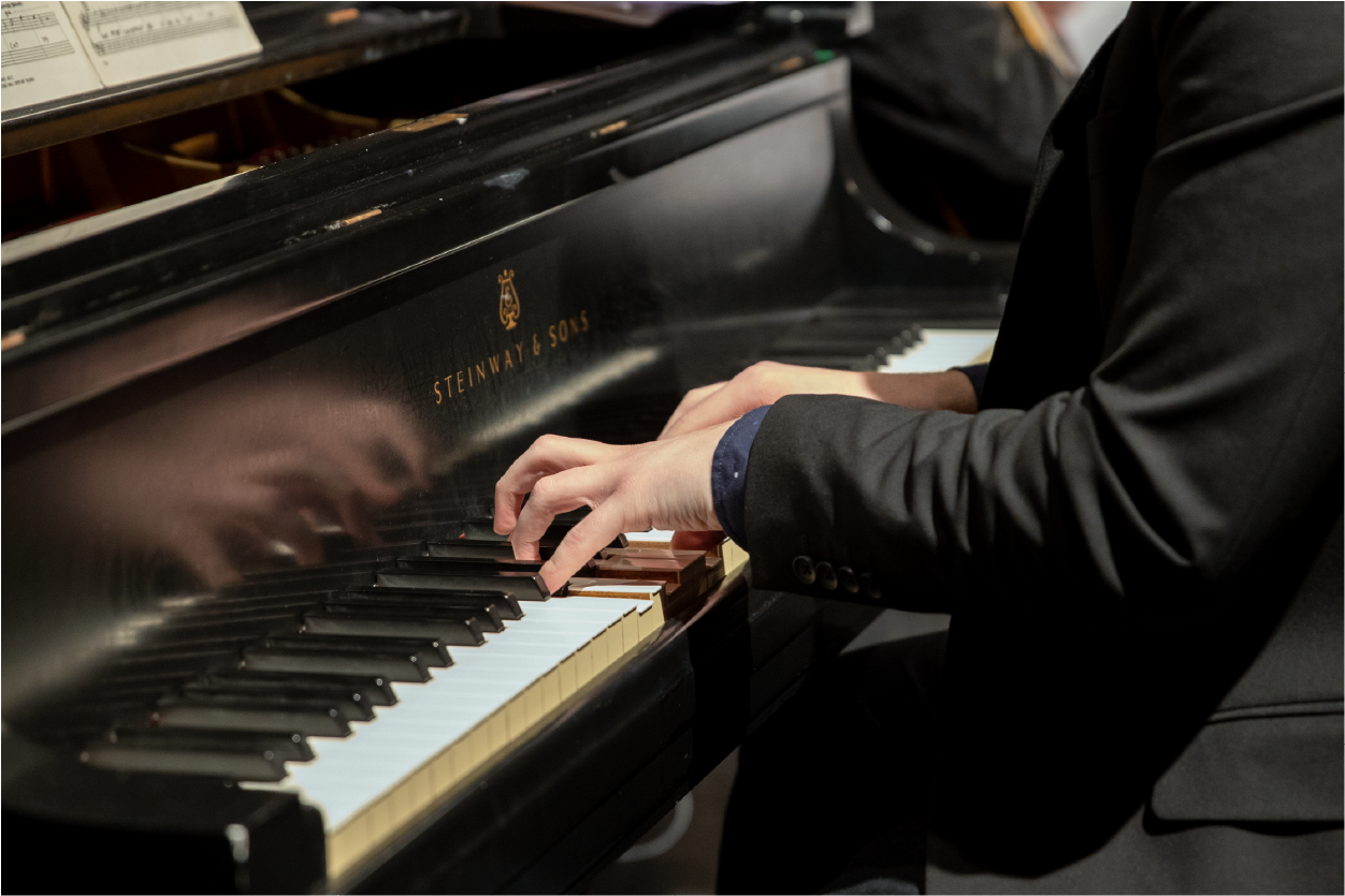 A closeup of a jazz pianist's hands playing a chord