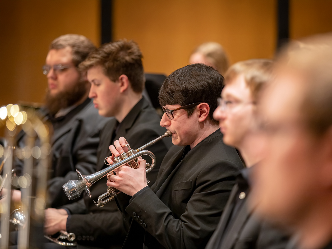 WSU band students in the brass section play on stage