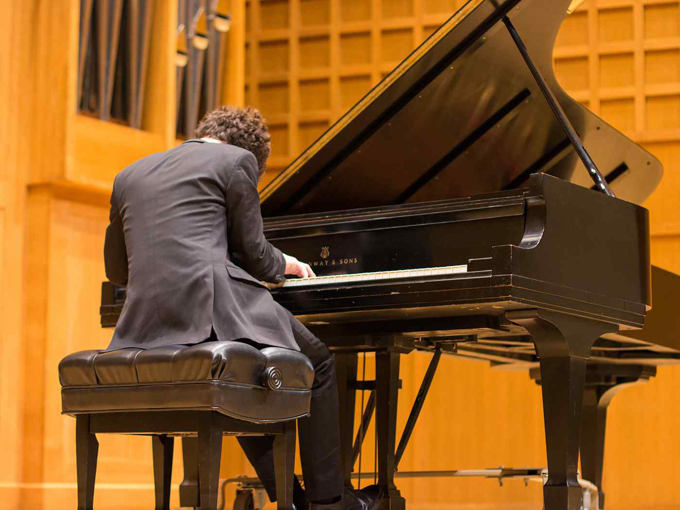 A student soloist plays the piano in Wiedemann Hall