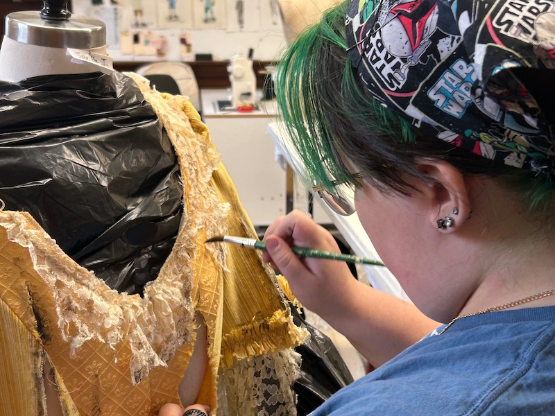 Twelfth Night costume design student working on a costume design