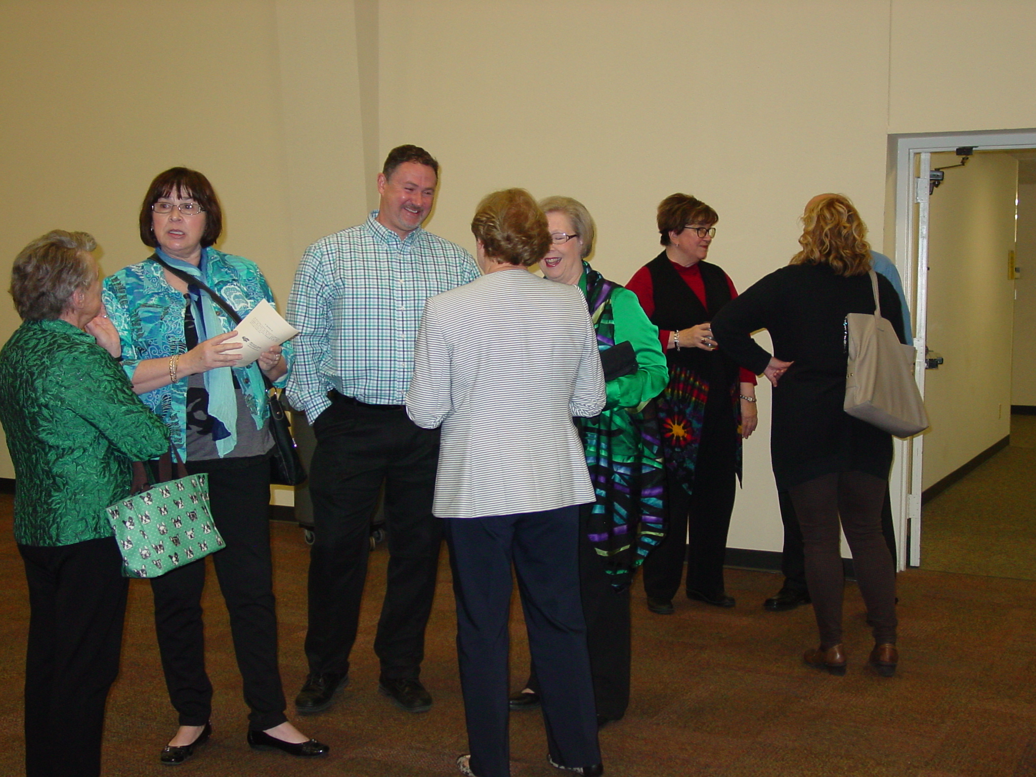 Many guests chatting at retirement reception. 