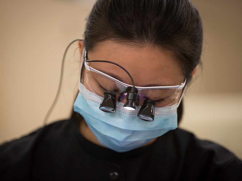Dental hygiene student wearing dental eye loupes Dental hygiene student wearing dental eye loupes