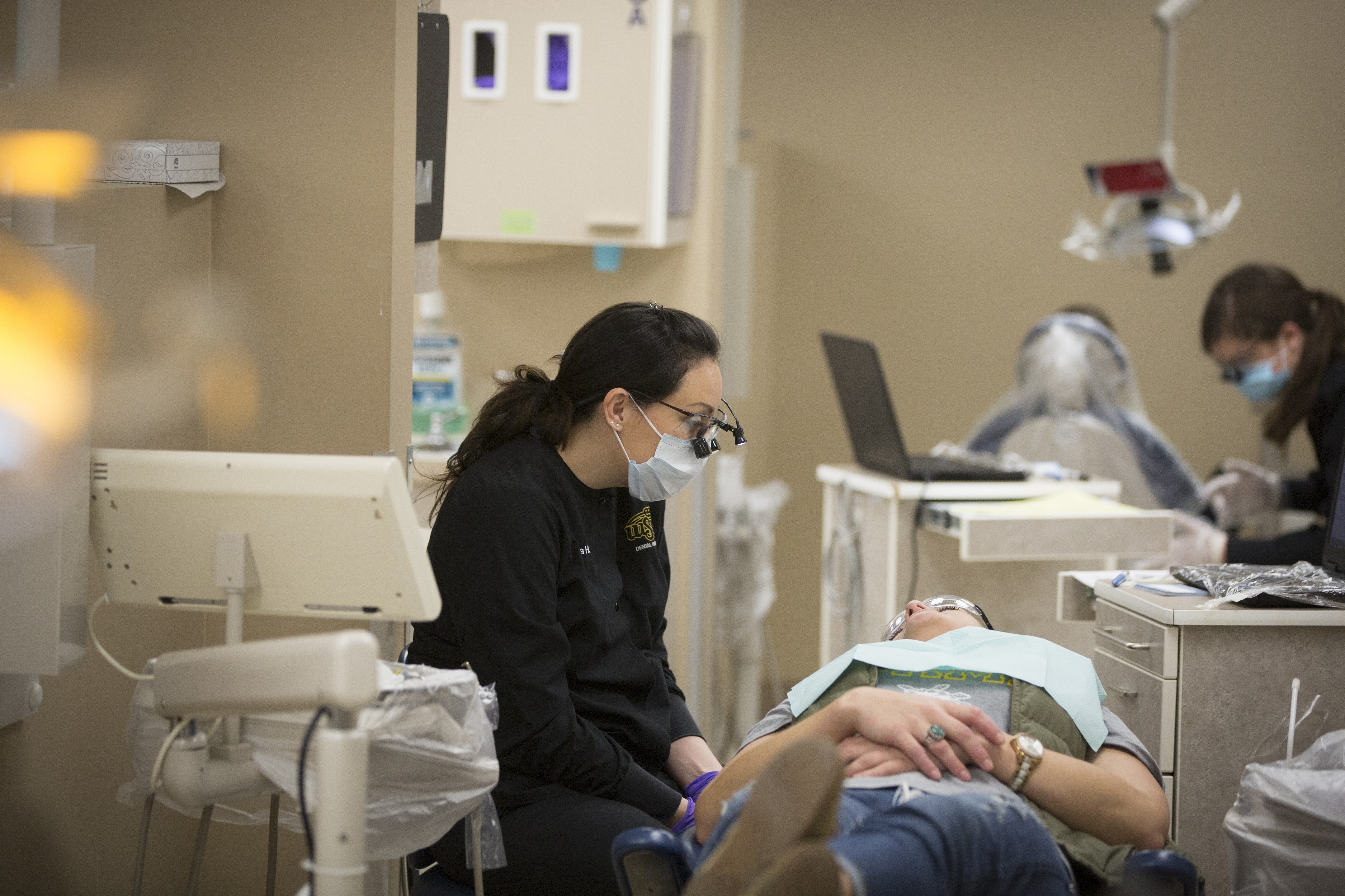 dental hygiene student talking to patient