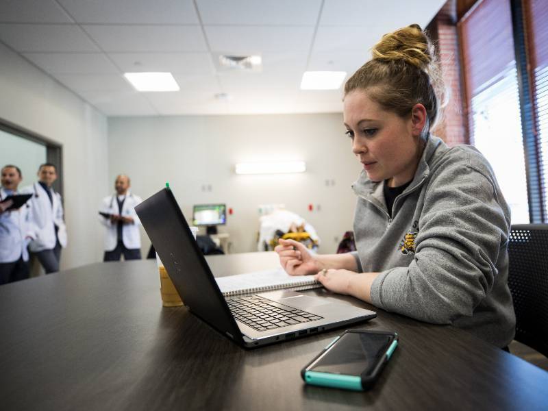 A group of professionals examines a data visualization