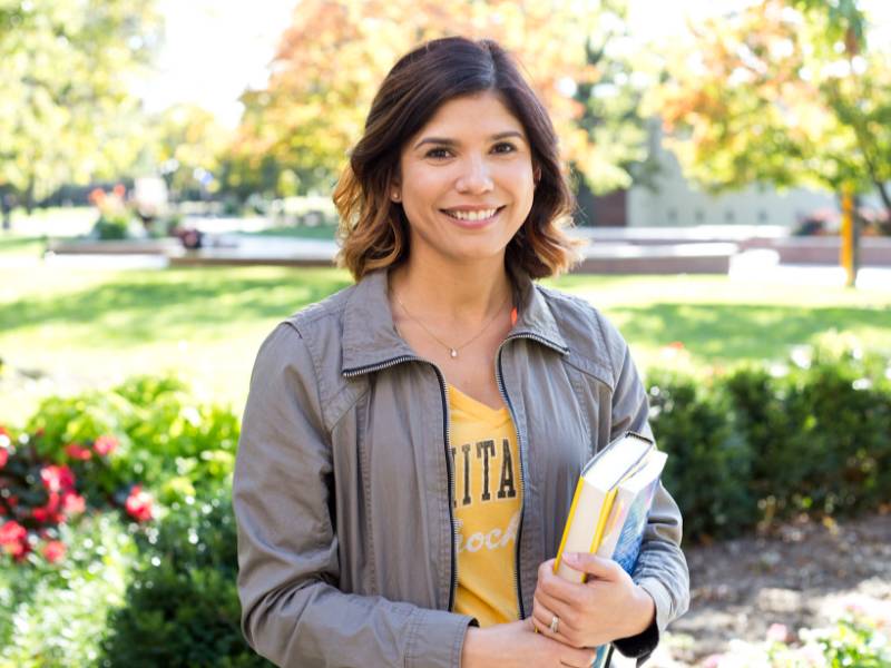 WSU student with a book outside