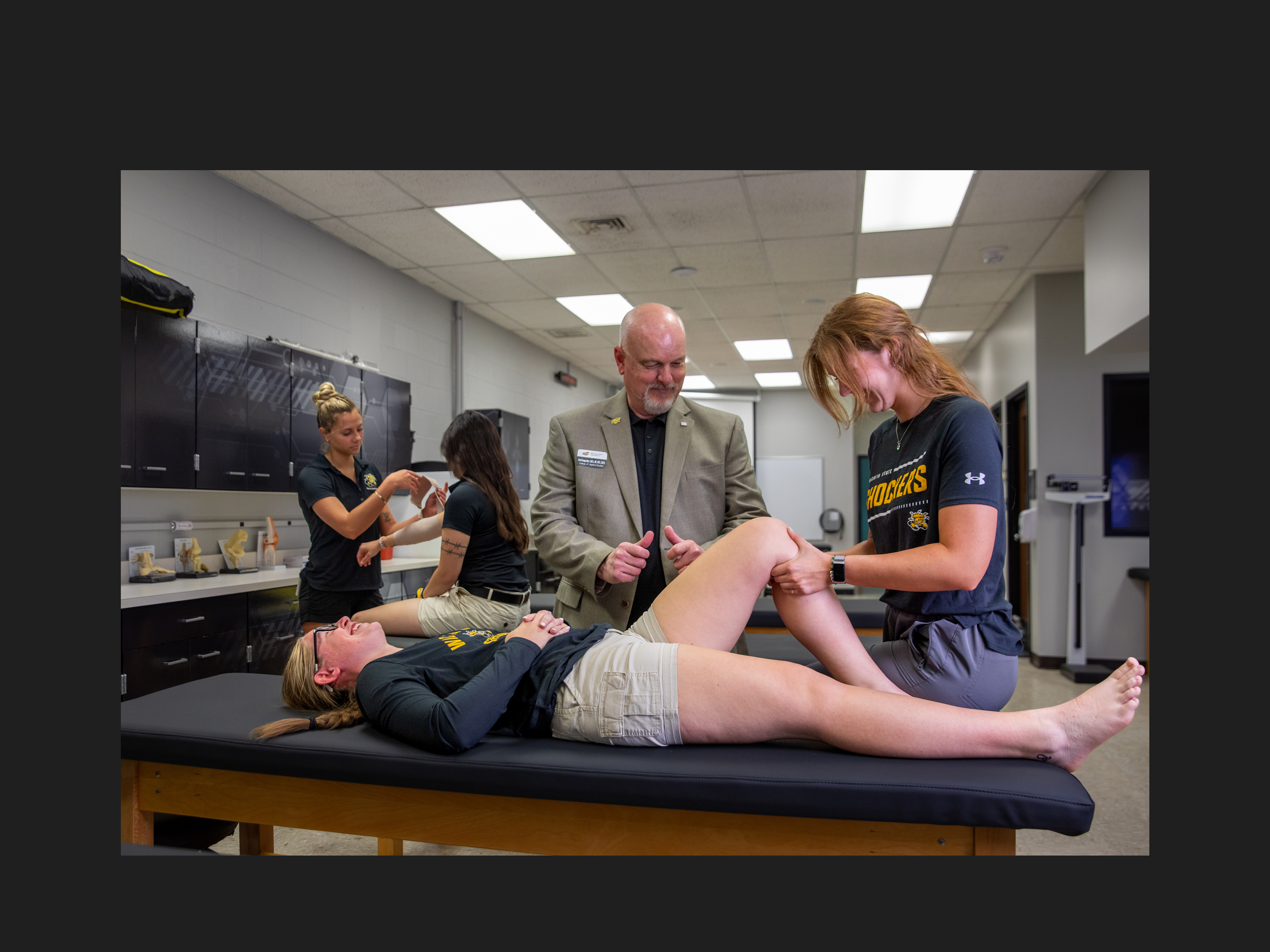 Students practice hands‑on athletic training techniques in a clinical lab.