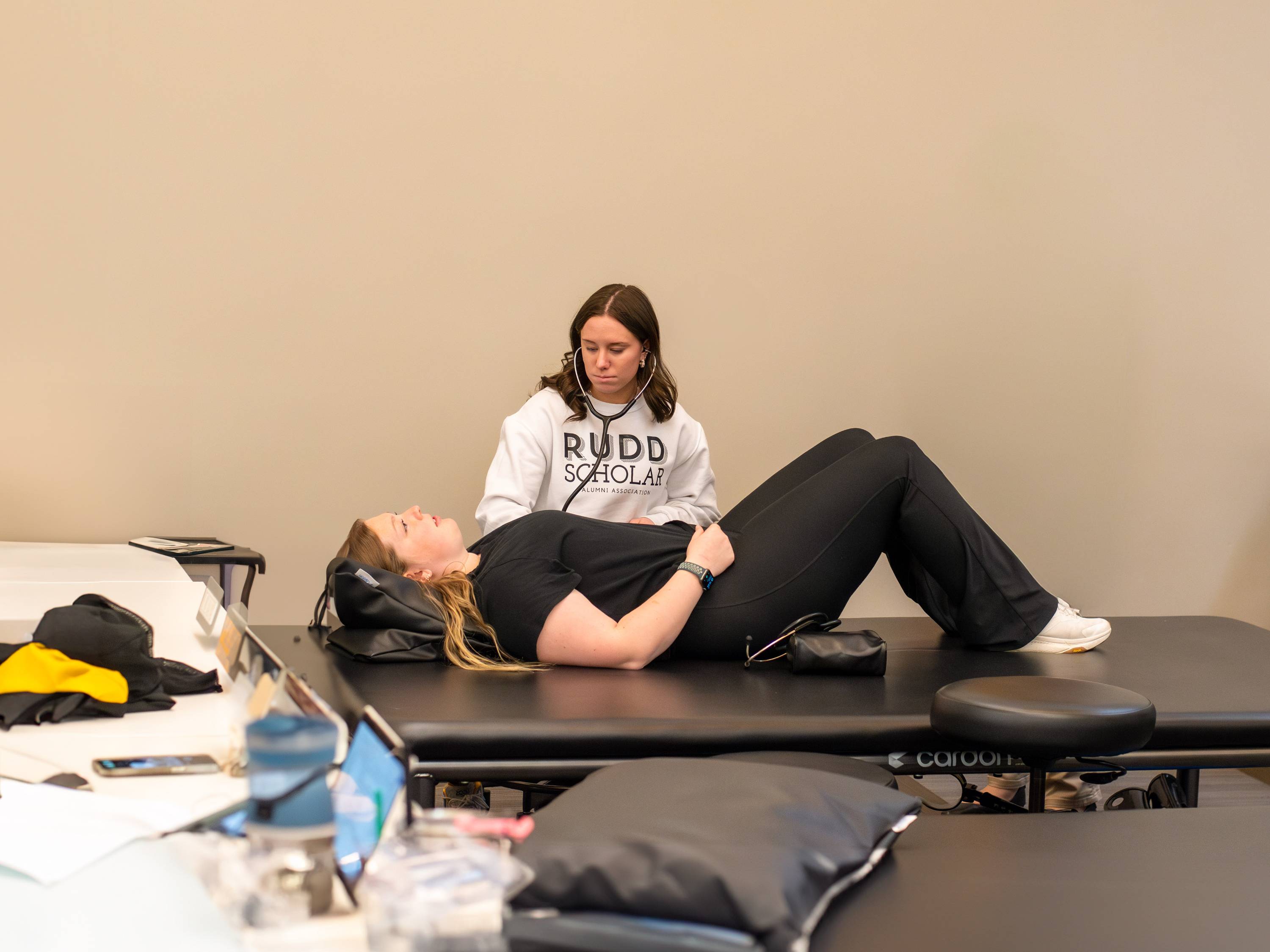 A professor showing students how to use an ultrasound system in classroom.