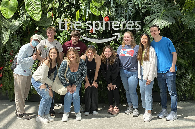 Students in front of a sign that reads "The Spheres" in Portland