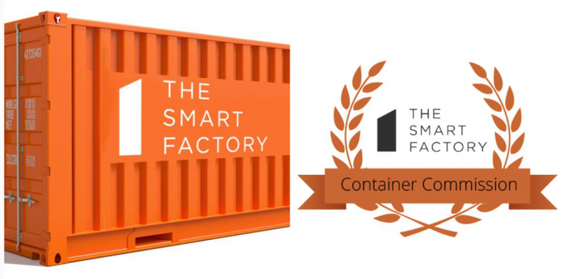 An orange shipping container displays the words"The Smart Factory." Next the shipping container is the The Smart Factory's logo with orange leaves and a banner reading "Container Commission."