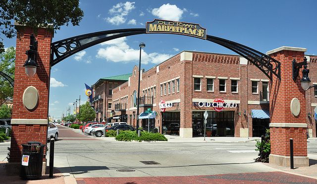 Photo of an arch that says Old Town Marketplace and buildings in the background