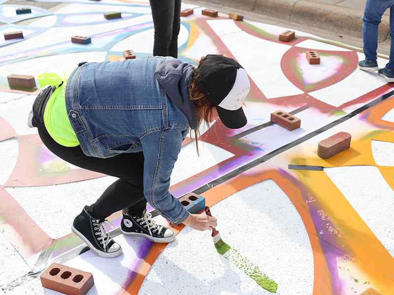 Students in the "Introduction to Community & Social Practices" class took part in the citywide 2020 Vision initiative to create a street mural in the Douglas Design District.