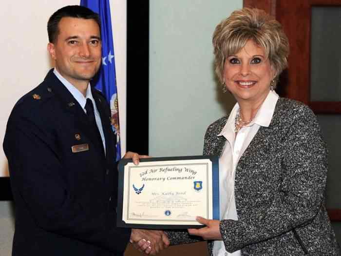 Photo of Kathy Bond receiving an honorary commander award. 