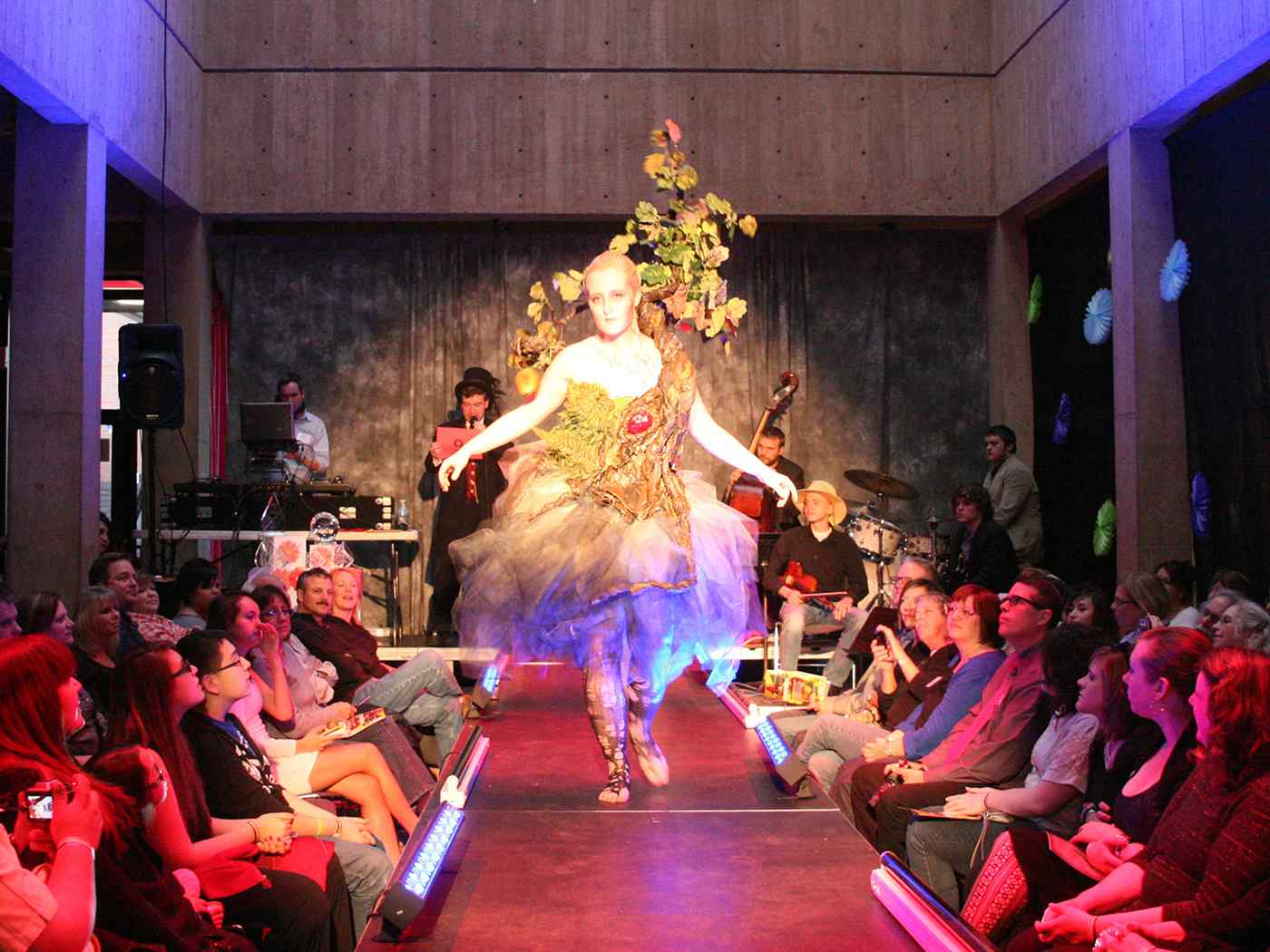 Student taking part in a theatrical production on a catwalk-like structure.