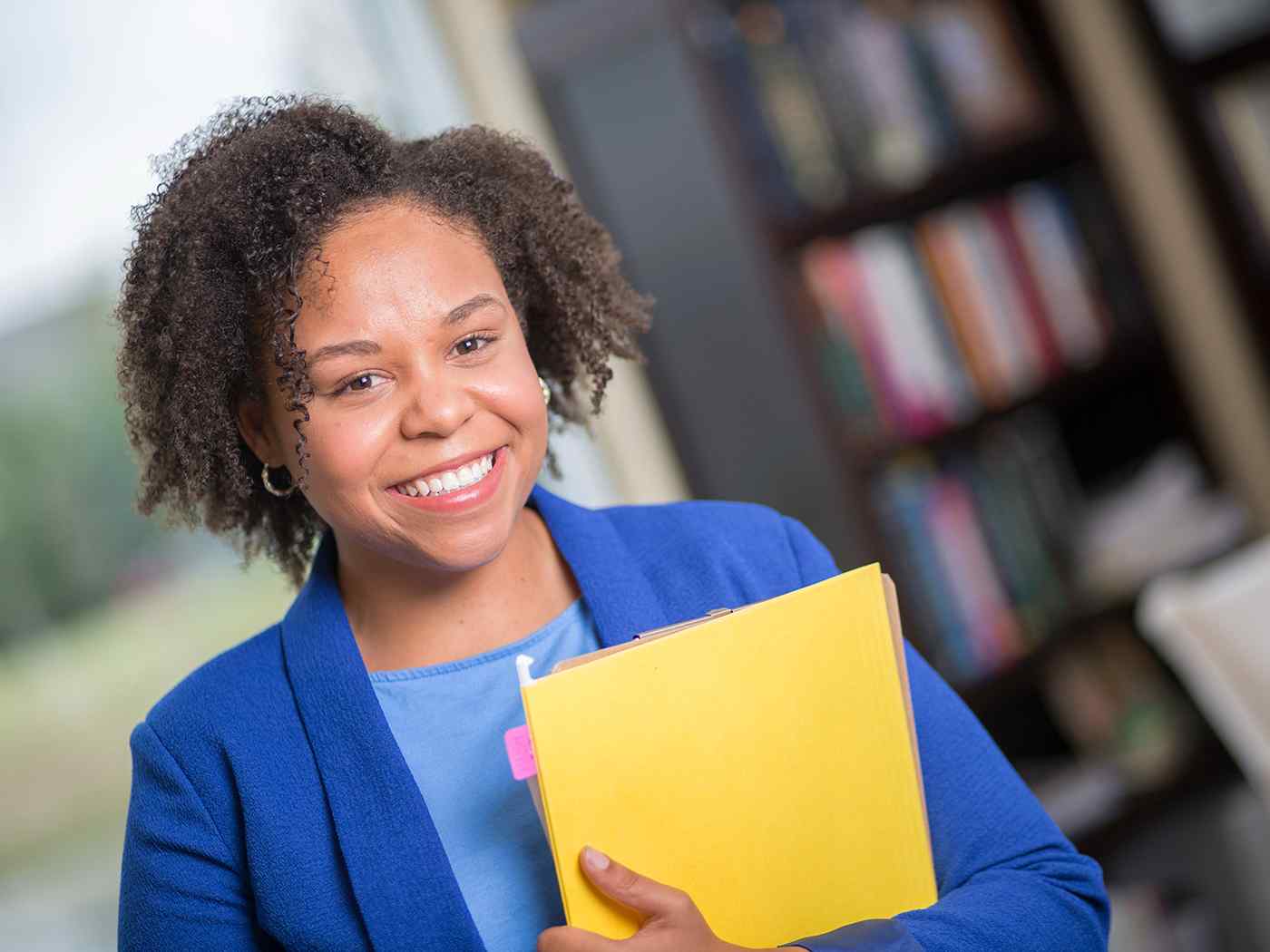 Female business student holding personnel files