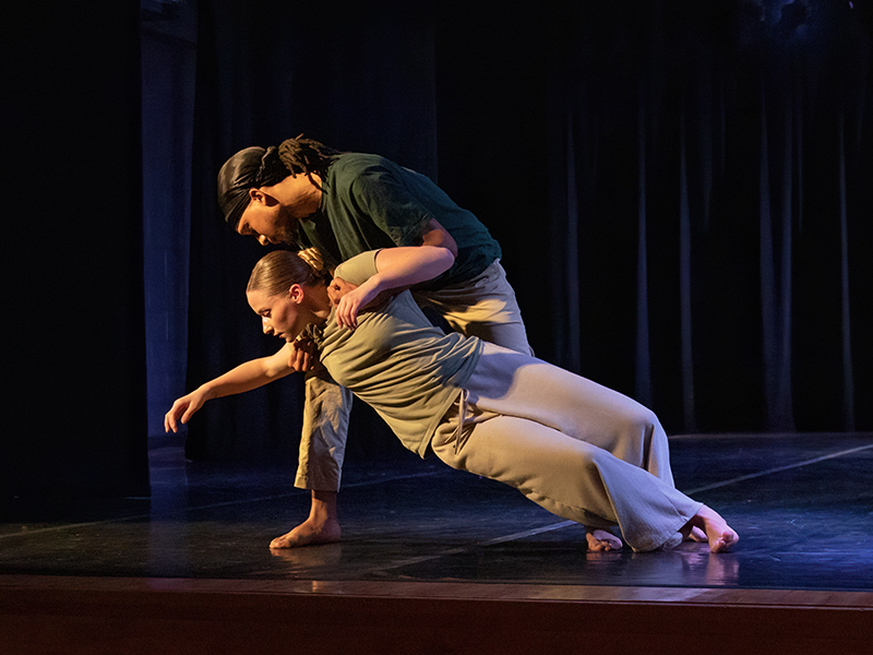 Two student dancers on stage.