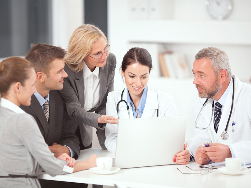 A small group of health care professionals meets