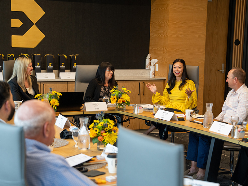 Members of the Barton School Hospitality Advisory Board meeting in a conference room.