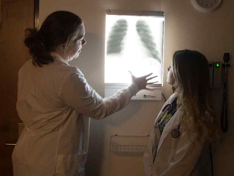 A nursing student and their mentor examine an x-ray