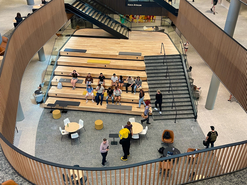 Students lounge on the social stair in the Woolsey atrium