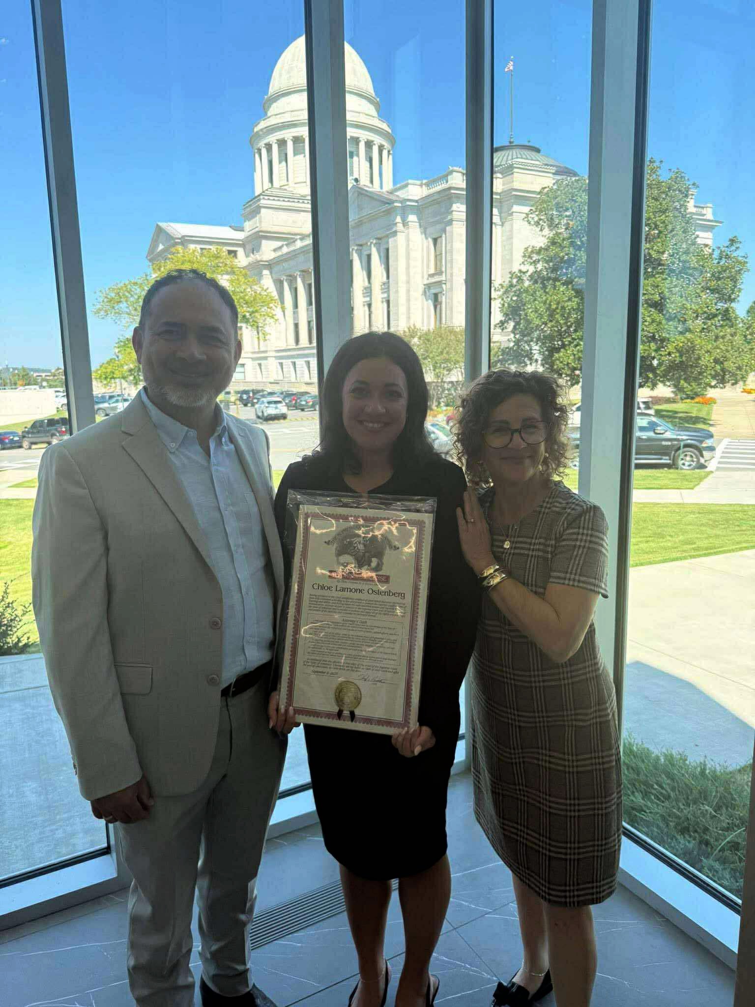 Pam with group posing with state building in background