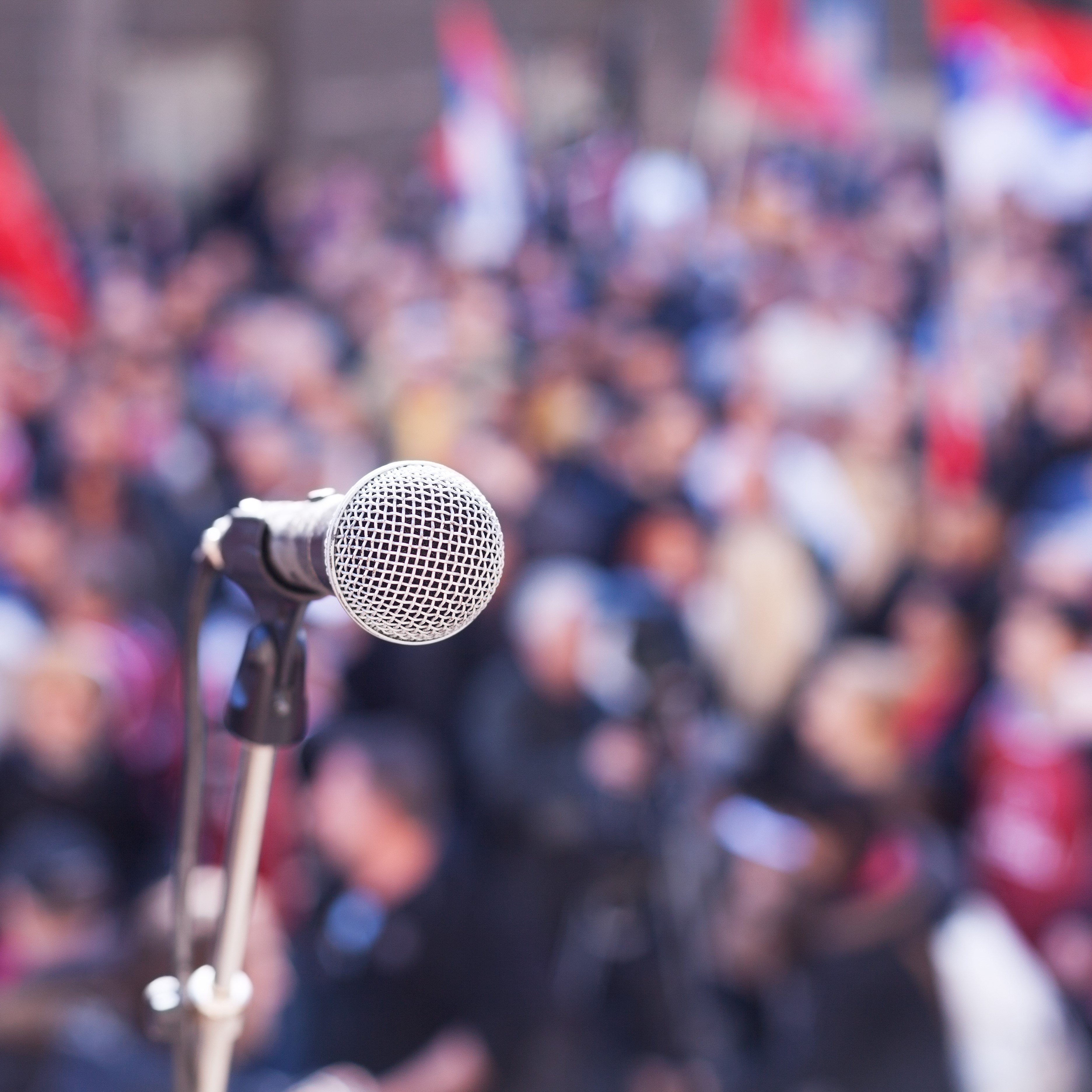 image of a mic in front of a political rally
