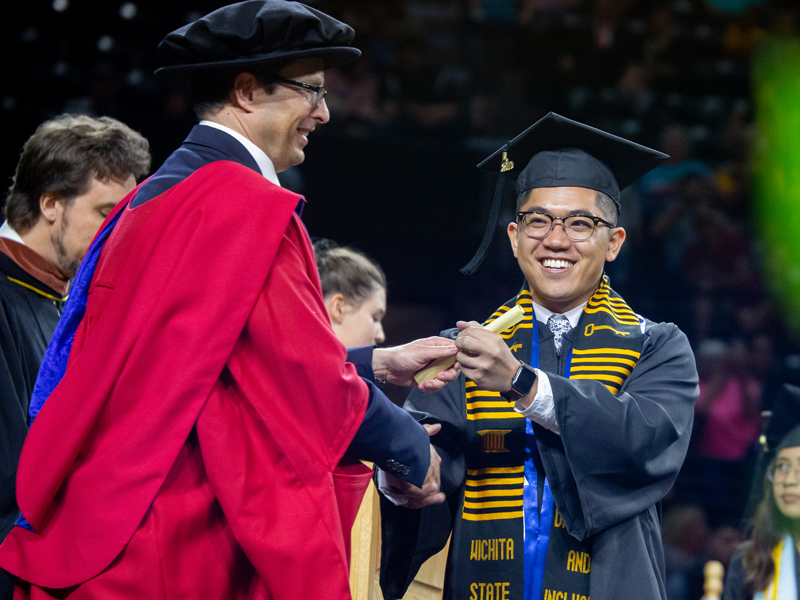 LAS Dean Hippisley congratulating a new graduate on state at commencement