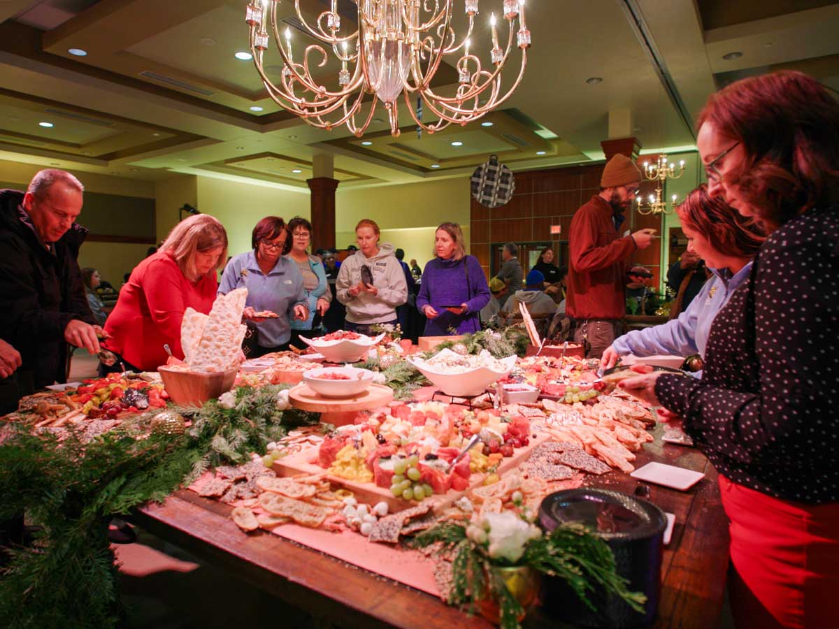 Faculty and staff grab food at the annual holiday party