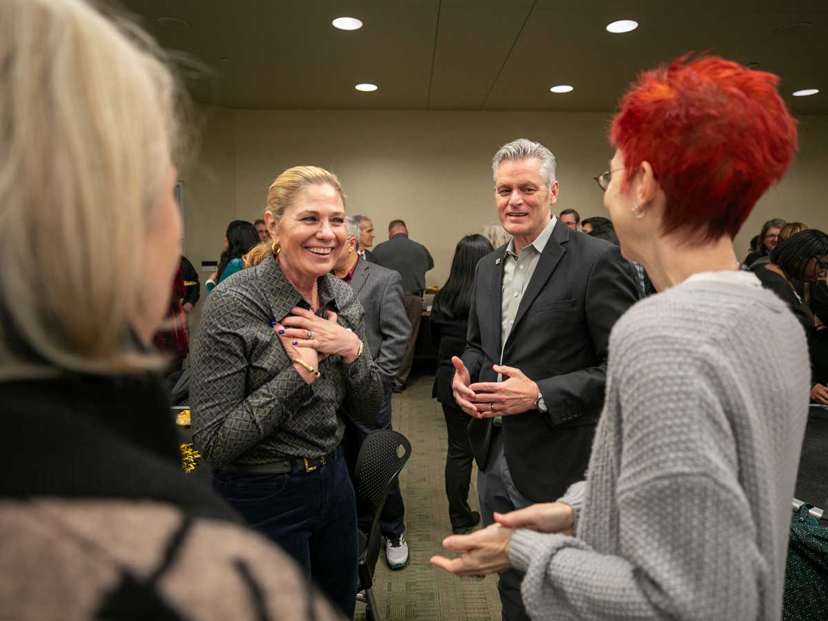 Monica Lounsbery speaks with guests at her welcome event