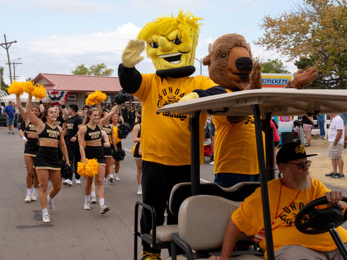 WuShock and Ike parade around the Kansas State Fair on a golf cart