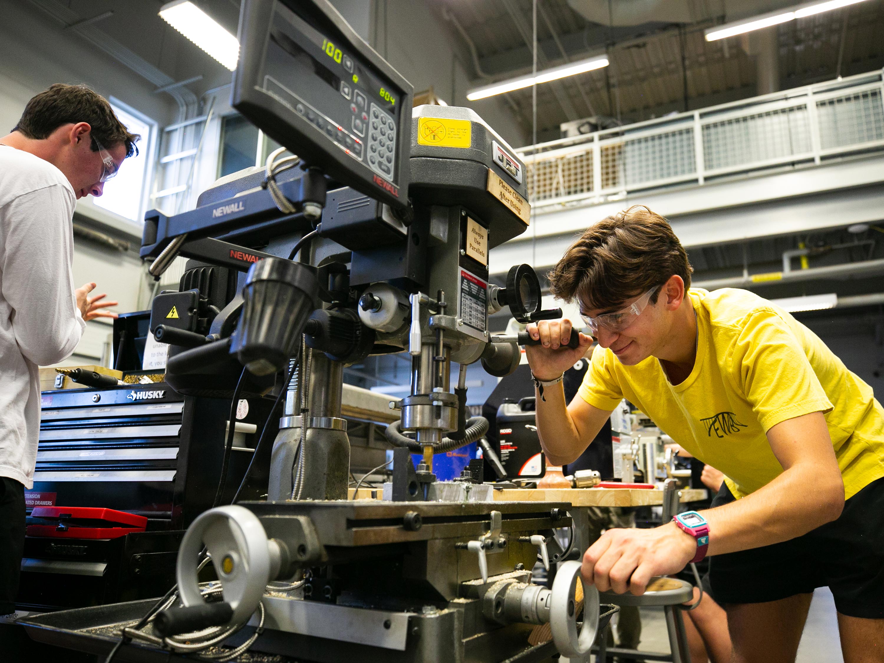 A student uses machinery in an engineering lab.