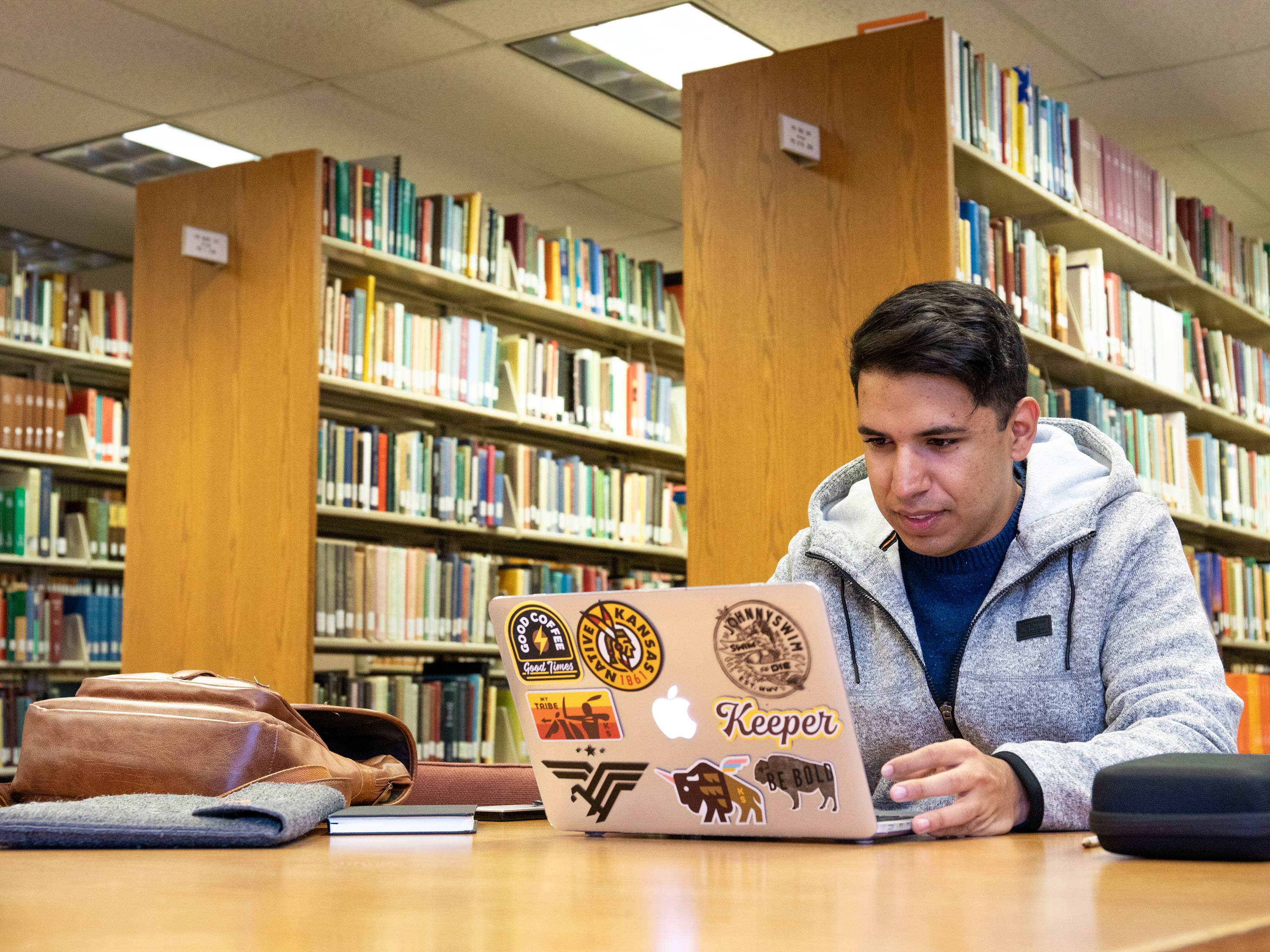 A student works at a laptop in Ablah Library.