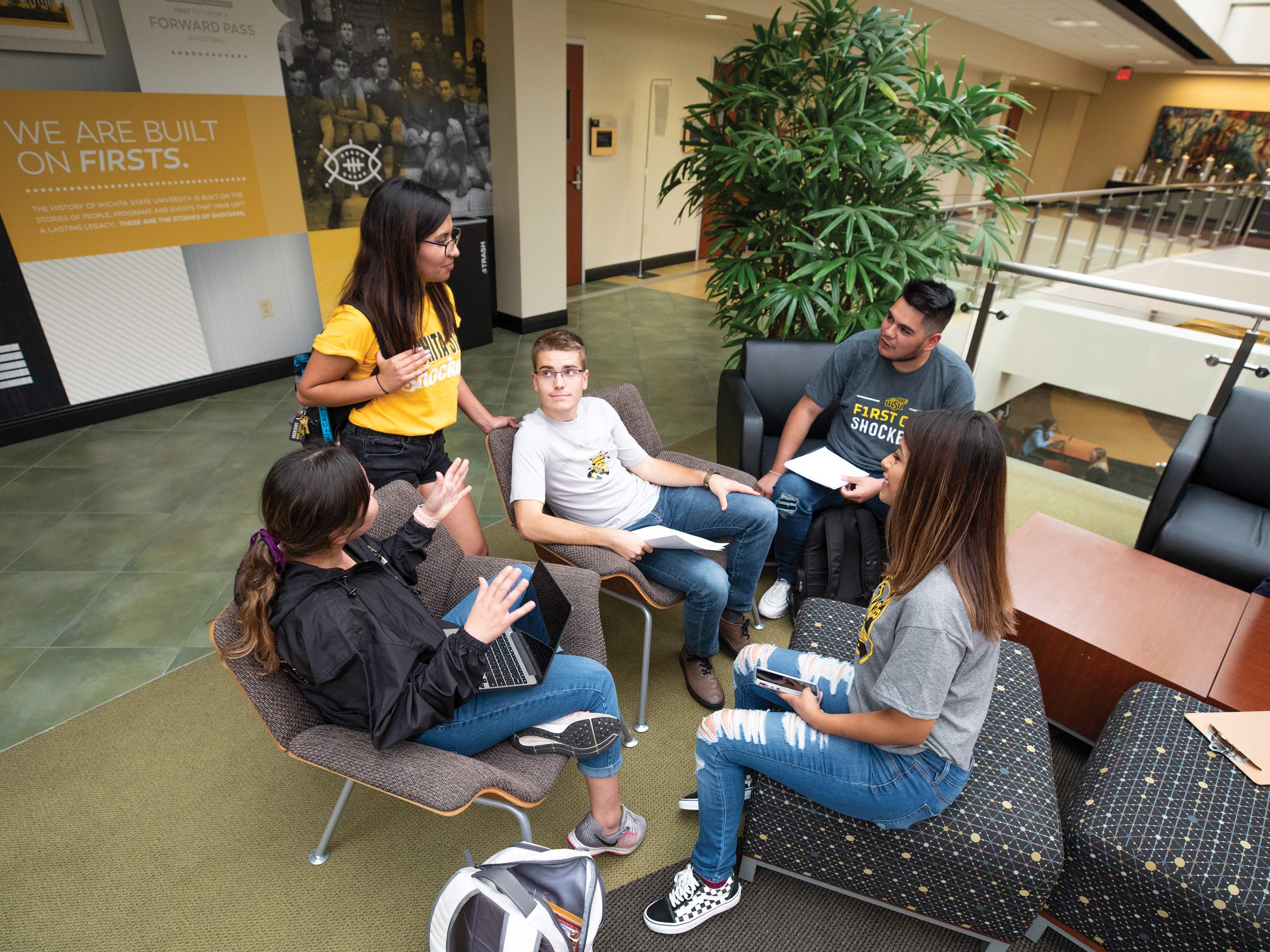Students talk as a group on the second floor of the Rhatigan Student Center.