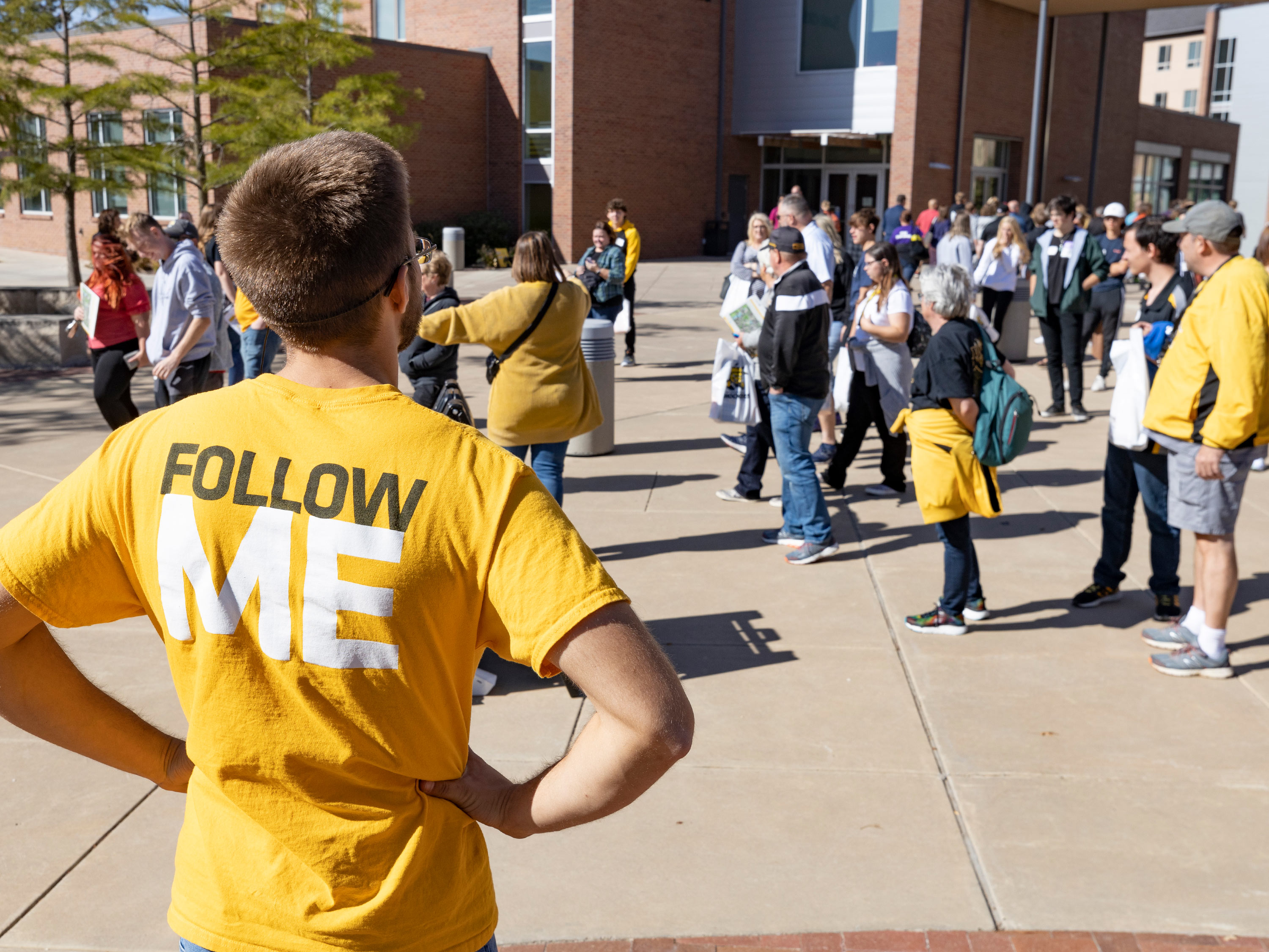 A Shocker Navigator leads a group on a campus tour of Wichita State University