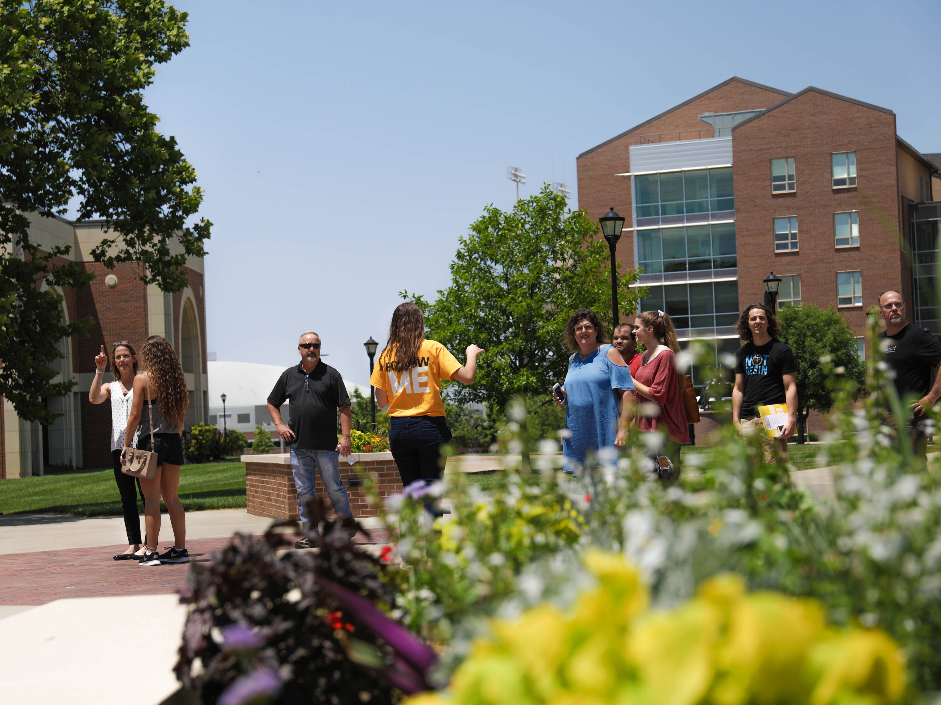 Students and their parents tour campus in the summer