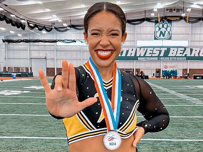 Destanee Brigman-Reed poses with her dance medal.