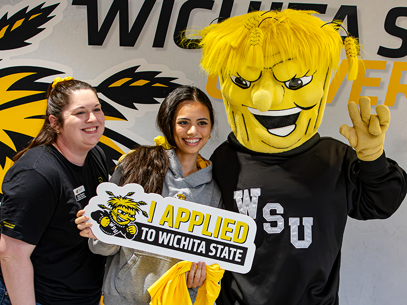 A student poses for a photo after applying to Wichita State University.
