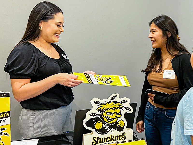 Elsie Hernandez, Wichita State diversity recruiter, chats with students during a event.