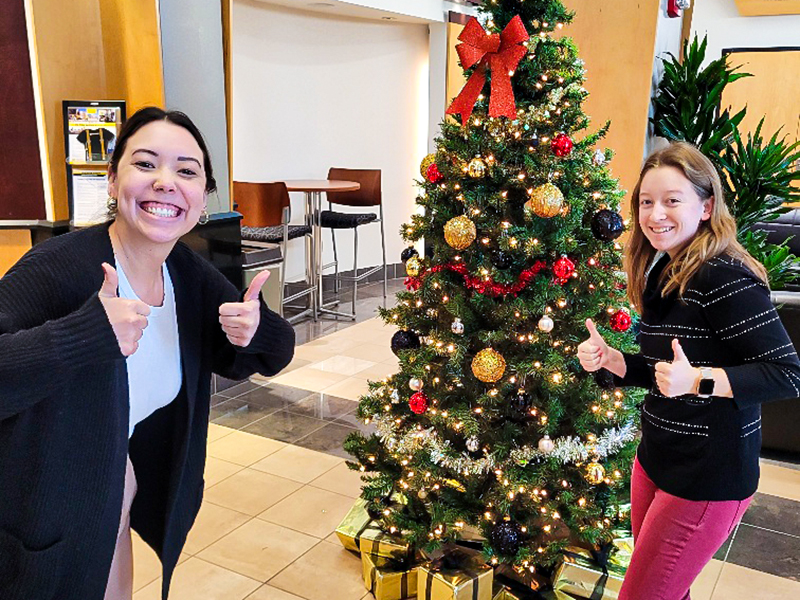 Anna Dixon and Savana Larrison decorate the Wichita State Admissions Christmas tree.