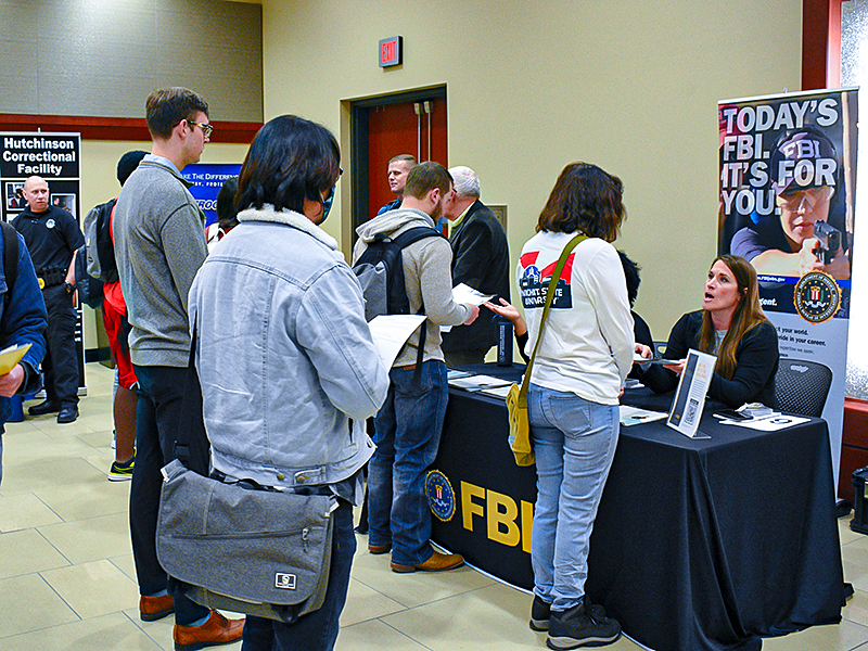 Students visit the FBI table during the School of Criminal Justice career fair.