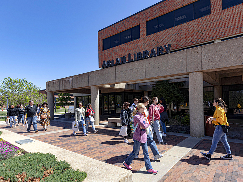 Nikky Bloomquist walks by Ablah Library during a campus tour.