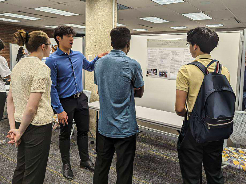 Gary Tran and Don Boyd present their research during the FYRE in STEM Research Showcase on May 8, 2023 in Ablah Library.