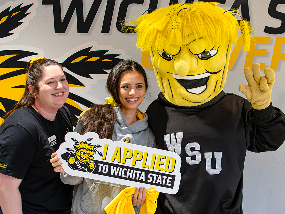 Rani Sommers, Recruitment Coordinator at the W. Frank Barton School of Business, and WuShock pose for a photo with a prospective student.